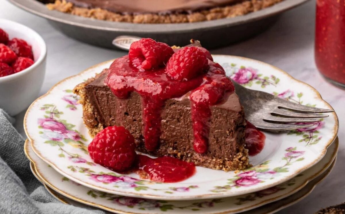vegan chocolate cheesecake with raspberry coulis and a no-bake filling
