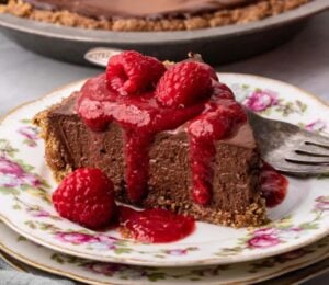 vegan chocolate cheesecake with raspberry coulis and a no-bake filling