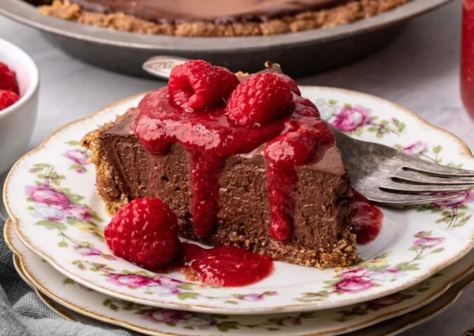 vegan chocolate cheesecake with raspberry coulis and a no-bake filling