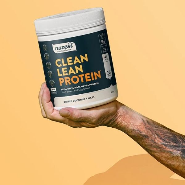 Photo shows someone holding up a carton of Nuzest's Clean Lean Protein