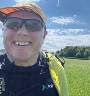 Photo is a selfie taken by vegan runner Bob Yates on a sunny day in a grassy field