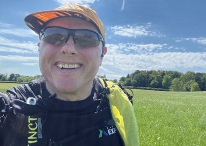 Photo is a selfie taken by vegan runner Bob Yates on a sunny day in a grassy field