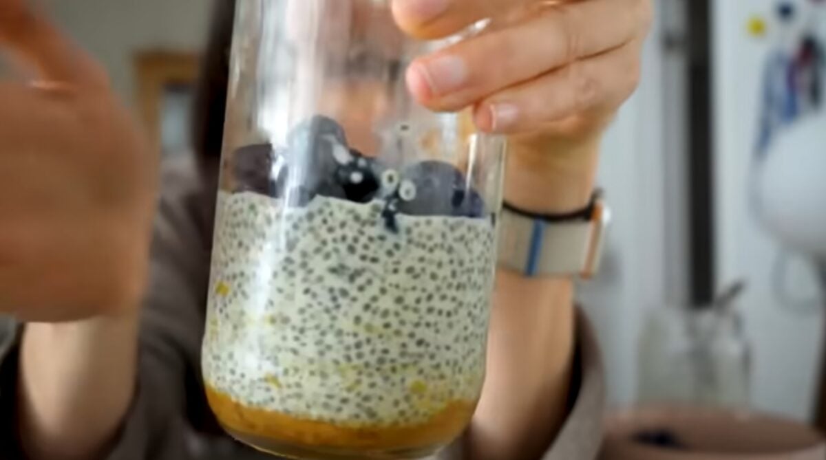 Merle O'Neal holding up a chia pudding, a viral high-protein vegan breakfast