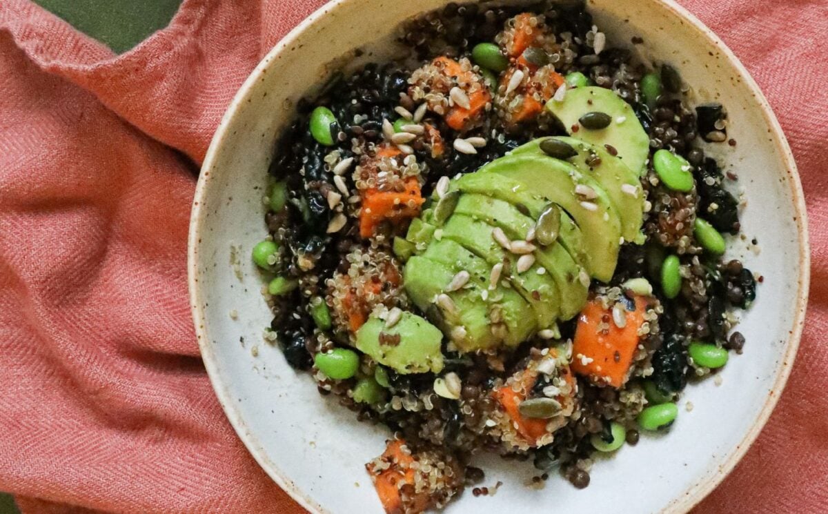a picture of an energizing post-gym workout salad made with sweet potato, edamame, lentils, orange, and avocado for vegan warm salad recipes