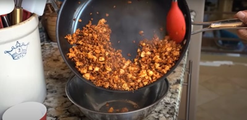 Miyoko Schinner pours the cooked tofu meat into a bowl to start prepping the layers of her gratin