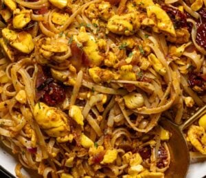 a bowl of ackee pasta with jerk marinade and tomato