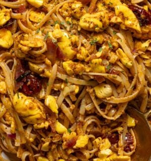 a bowl of ackee pasta with jerk marinade and tomato