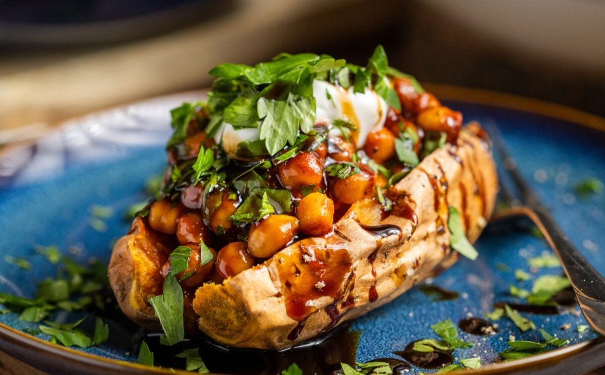 buffalo chickpeas on roasted sweet potato topped with coriander and coconut yogurt for vegan dinners where chickpeas are the start of the show