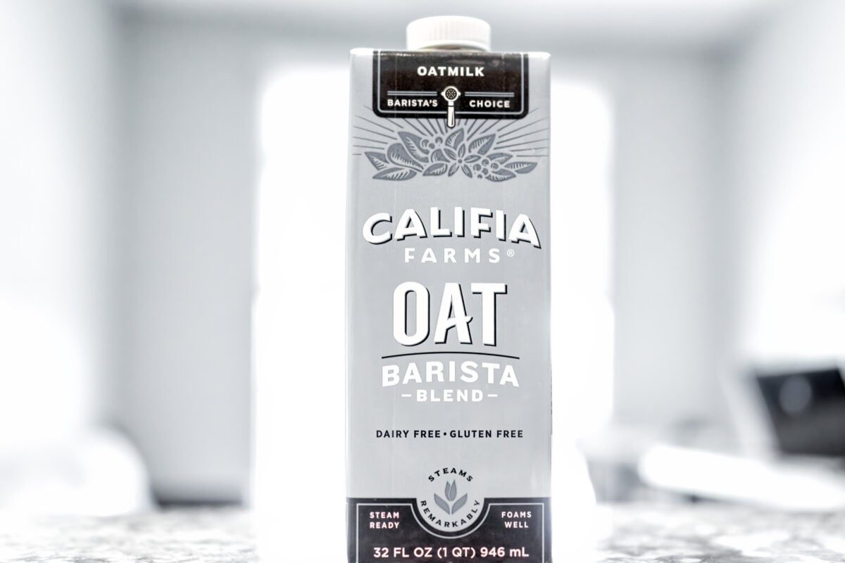 A black and white photo of a carton of Califia Farms oat milk