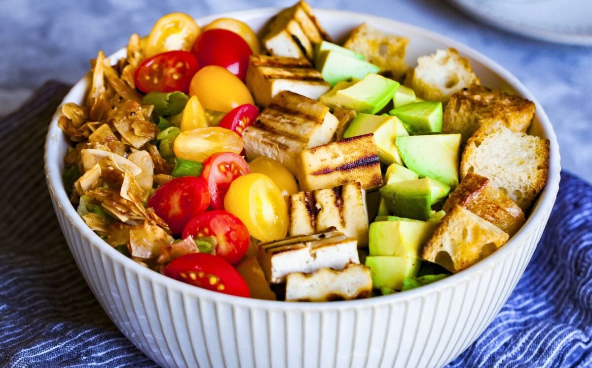 a bowl of California cobb salad with smoky coconut bacon