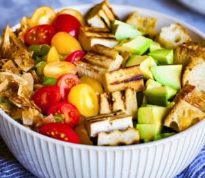 a bowl of California cobb salad with smoky coconut bacon