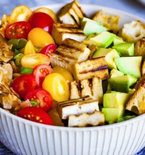 a bowl of California cobb salad with smoky coconut bacon