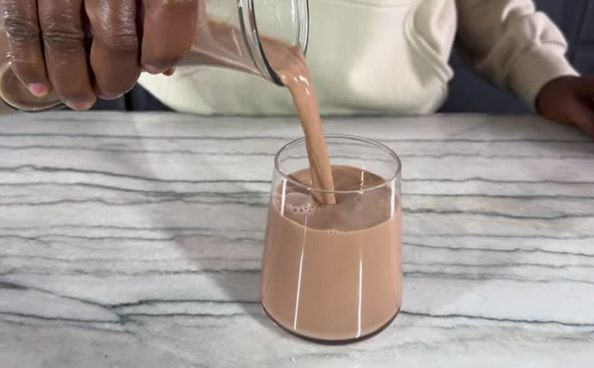 a glass of creamy chocolate oat milk from Healthy Vegan Eating