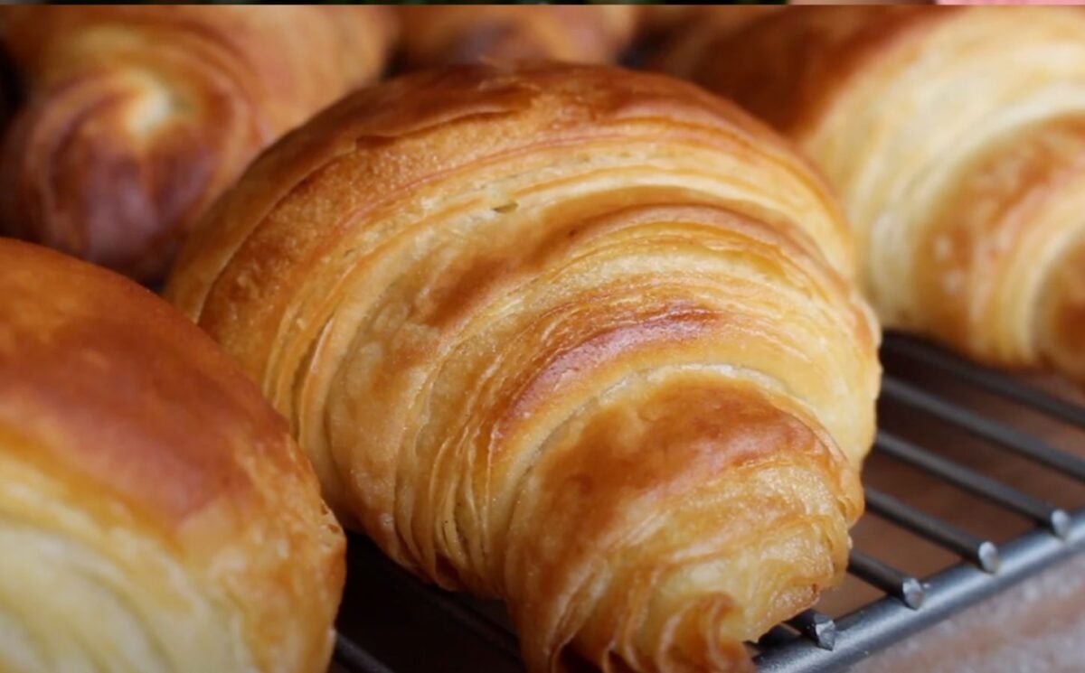 A close-up of some homemade vegan croissants on a baking tray