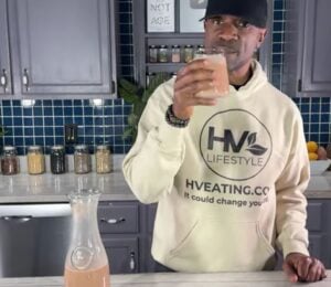 Javant at Healthy Vegan Eating drinking his creamy chocolate oat milk recipe