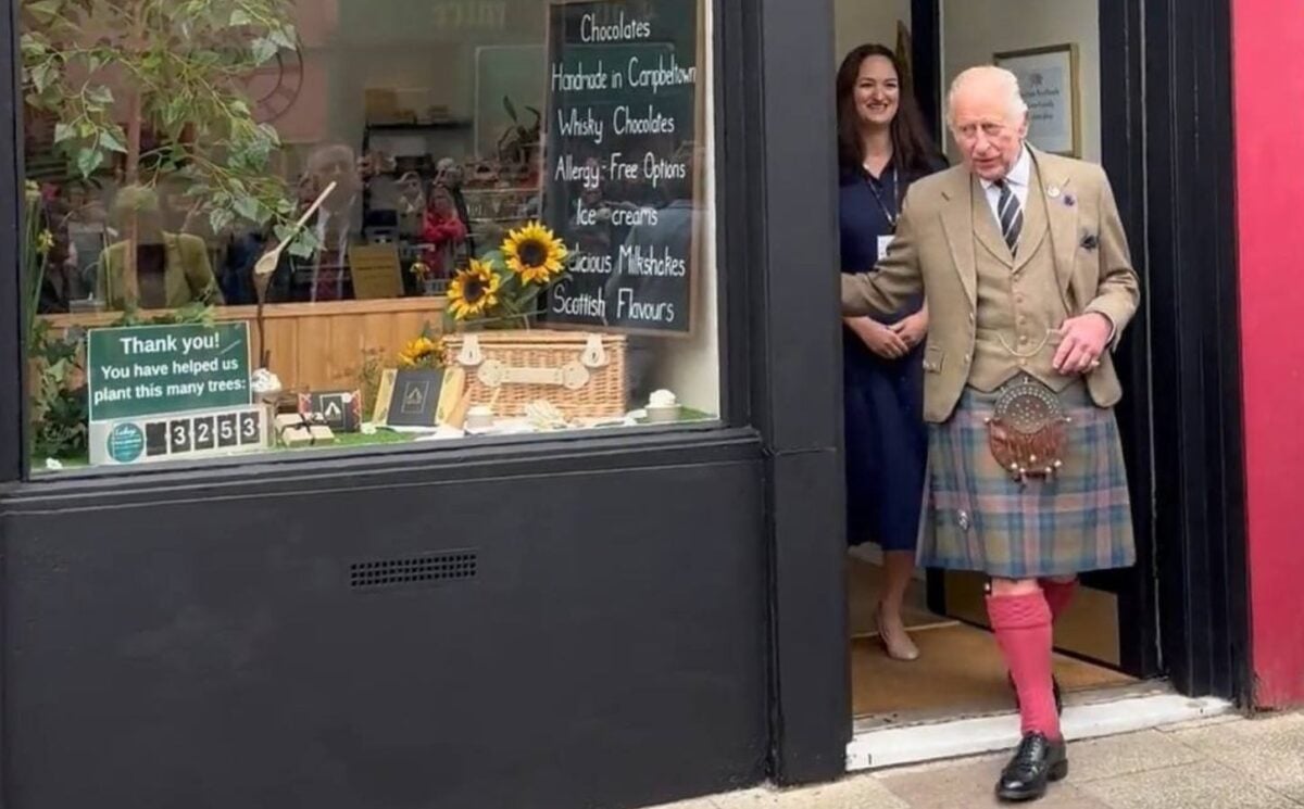 Photo shows King Charles and Fetcha Chocolates founder Fiona McArthur in the doorway of the shop