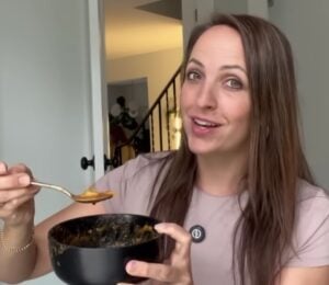 Ali Essig holding a bowl of vegan lasagna soup