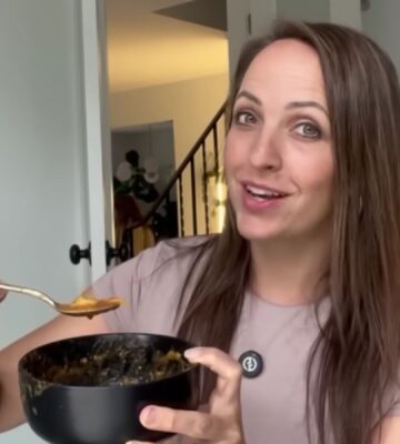 Ali Essig holding a bowl of vegan lasagna soup