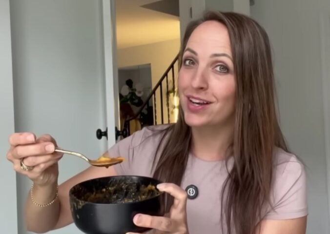 Ali Essig holding a bowl of vegan lasagna soup