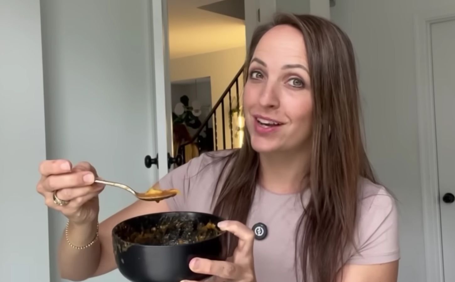 Ali Essig holding a bowl of vegan lasagna soup