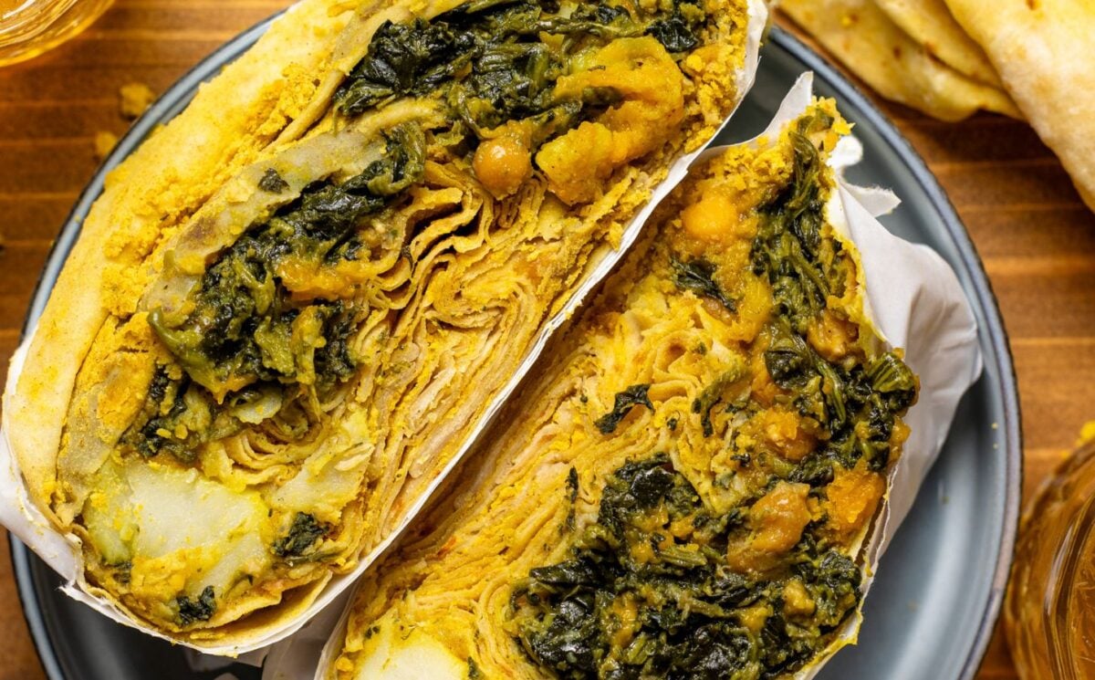 a loaded dhal puri roti with chana, aloo, and spinach