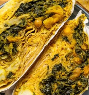 a loaded dhal puri roti with chana, aloo, and spinach