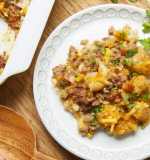a plate of maple mustard vegan tater hot dish with vegan beef, cheese, and tater tots