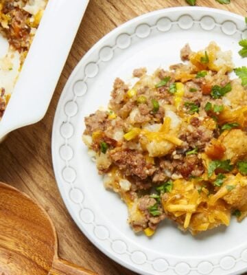 a plate of maple mustard vegan tater hot dish with vegan beef, cheese, and tater tots