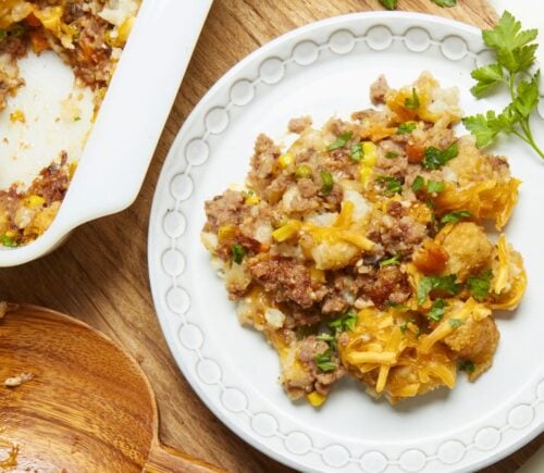 a plate of maple mustard vegan tater hot dish with vegan beef, cheese, and tater tots