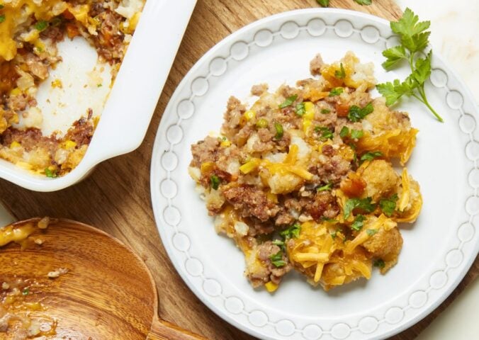 a plate of maple mustard vegan tater hot dish with vegan beef, cheese, and tater tots