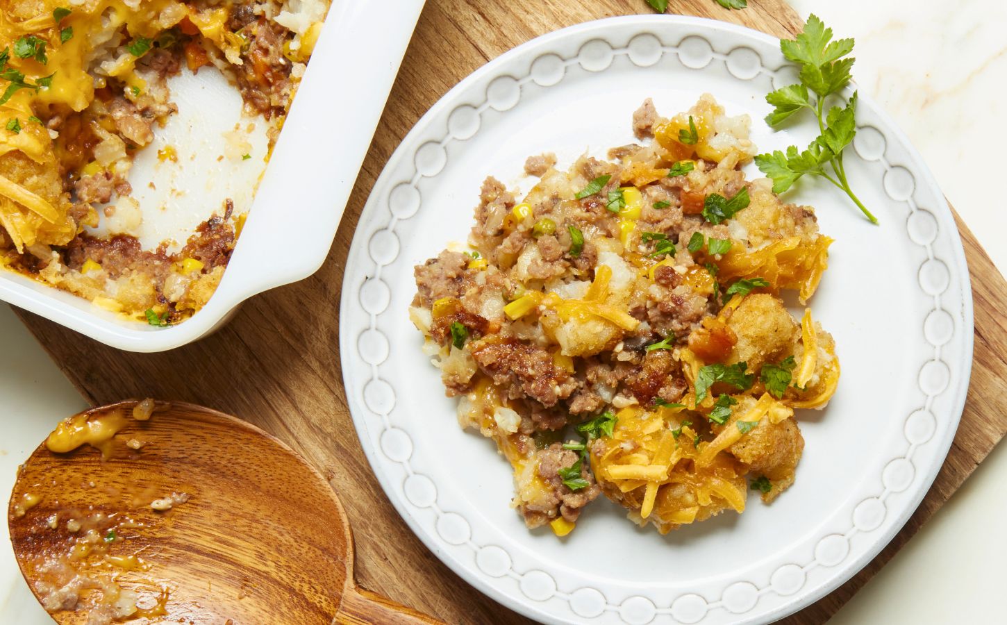 a plate of maple mustard vegan tater hot dish with vegan beef, cheese, and tater tots