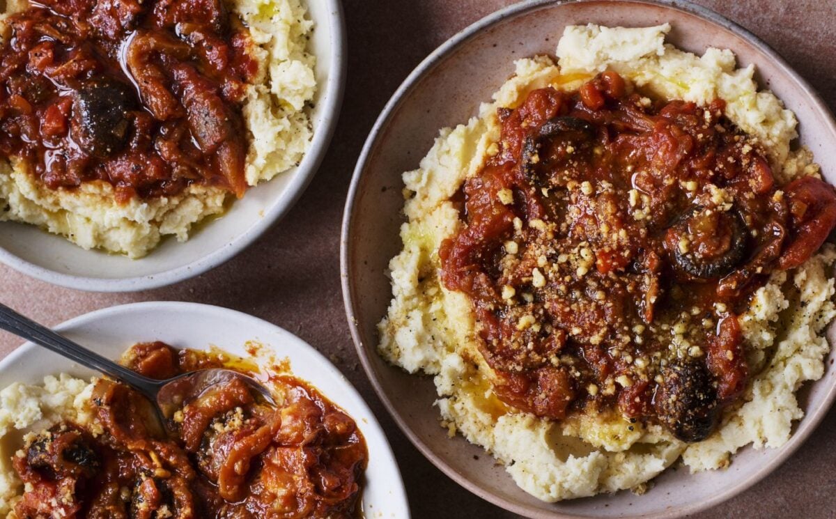 mediterranean-inspired vegan recipes like these three bowls of vegan pulled aubergine ragu on top of hummus infused mash