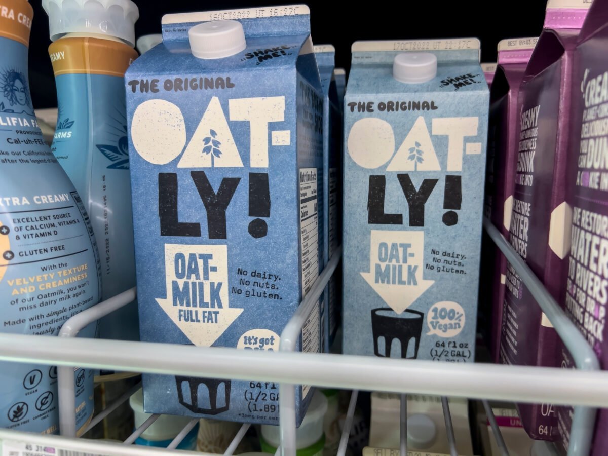 Cartons of Oatly milk in a supermarket