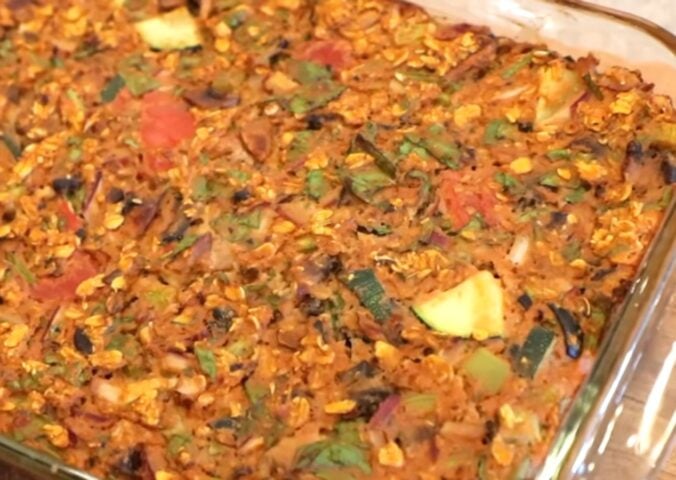 Shot of the viral pizza oatmeal in a clear glass baking dish after it came out of the oven