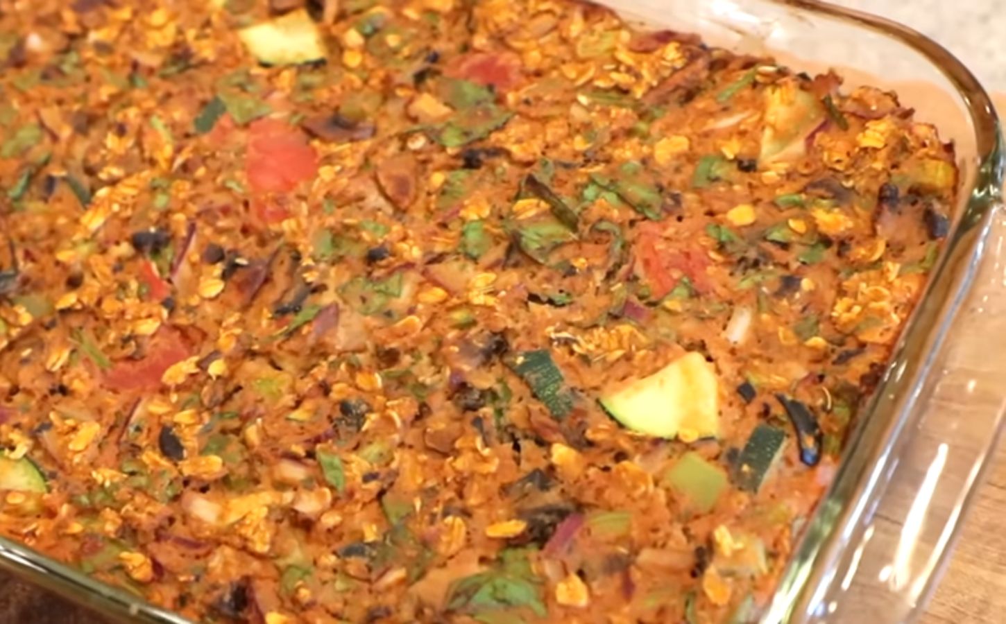 Shot of the viral pizza oatmeal in a clear glass baking dish after it came out of the oven