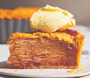 plant based apple pie with vegan flaky crust topped with vegan cream or ice cream