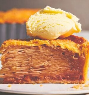 plant based apple pie with vegan flaky crust topped with vegan cream or ice cream