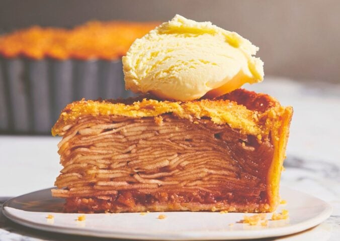 plant based apple pie with vegan flaky crust topped with vegan cream or ice cream