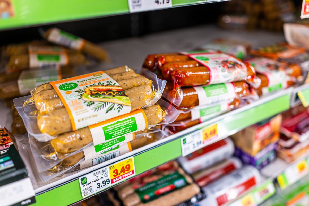 Photo shows a selection of vegetarian sausages and other packaged plant-based meat products on supermarket shelves