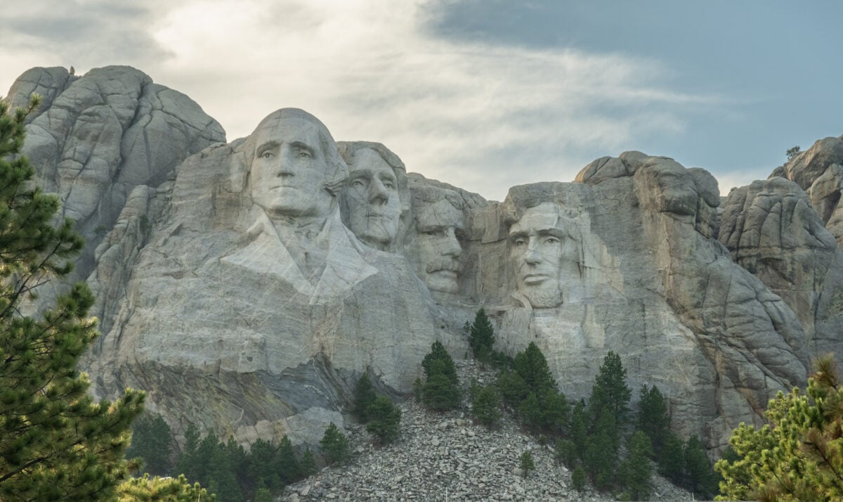 Photo shows Mount Rushmore and the surrounding trees