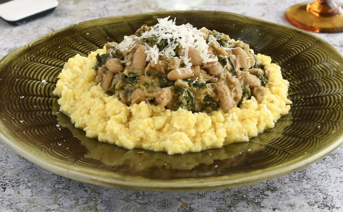 polenta topped with cannellini bean stew with kale and nutritional yeast