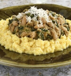polenta topped with cannellini bean stew with kale and nutritional yeast
