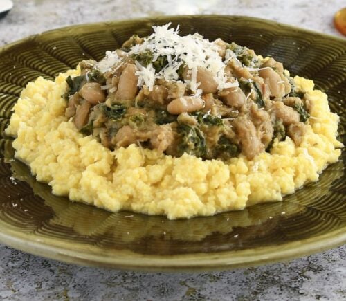 polenta topped with cannellini bean stew with kale and nutritional yeast