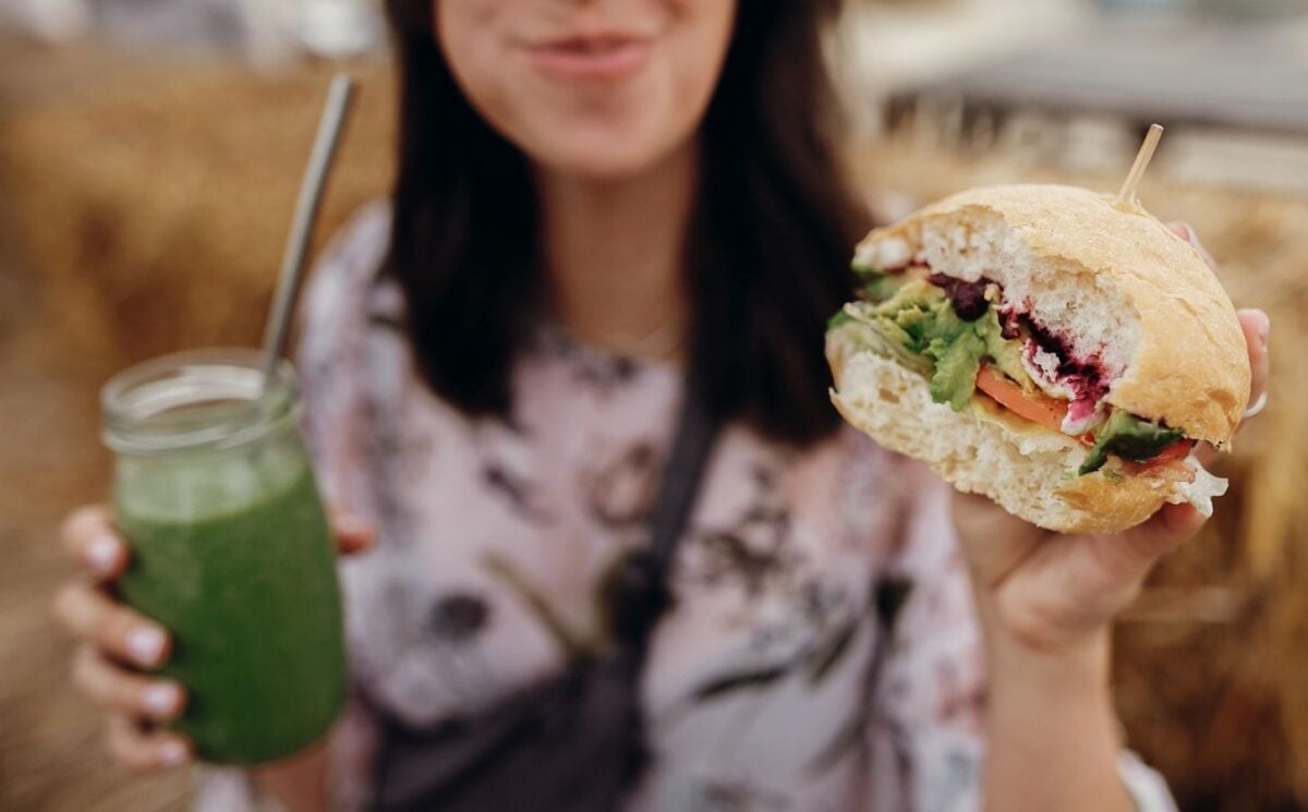A woman eating a vegan burger
