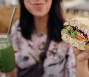 A woman eating a vegan burger