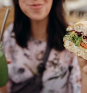 A woman eating a vegan burger