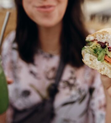 A woman eating a vegan burger