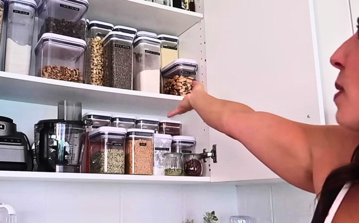 Stephanie from That Vegan Babe showing her grains and legumes cupboard
