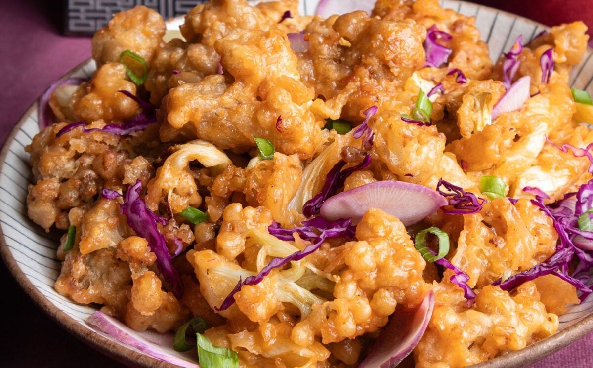 a plate of fried sweet and sour cauliflower with garnish for vegan recipes better than takeout