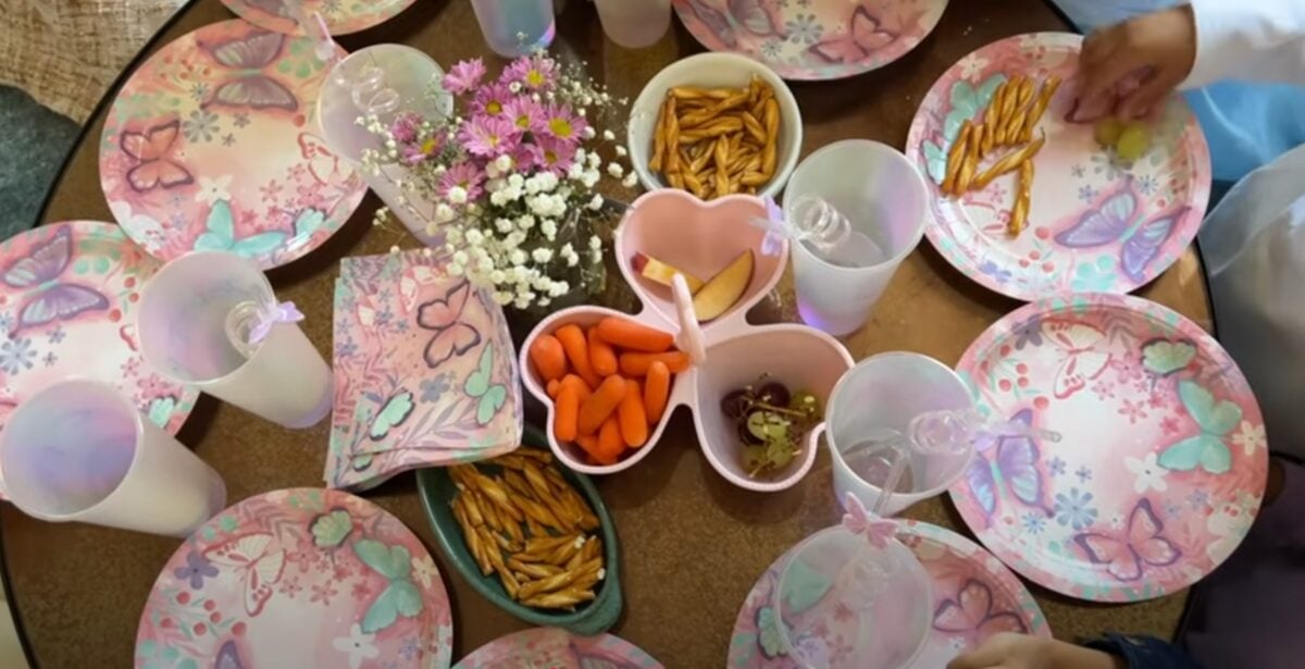 An array of butterfly plates and plant-based snacks on a table at a kids vegan birthday party